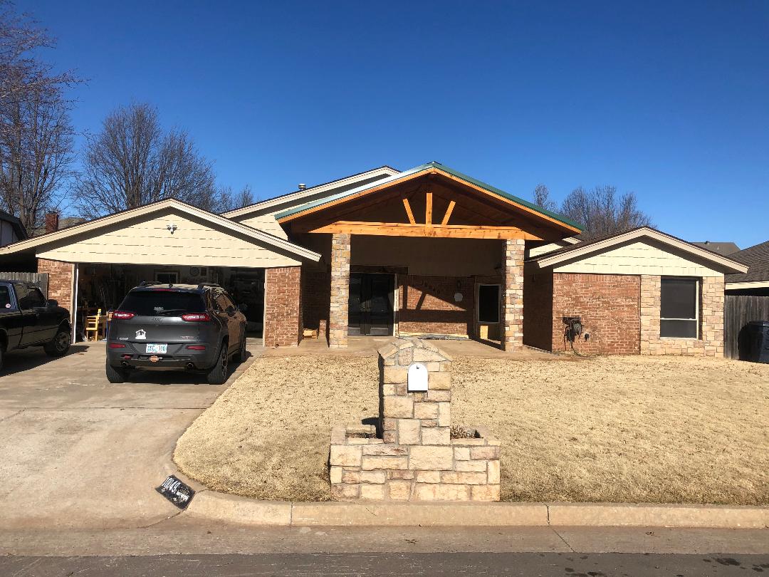 Brick ranch house with car in driveway
