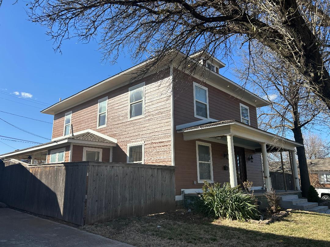 Two-story brown house with front porch
