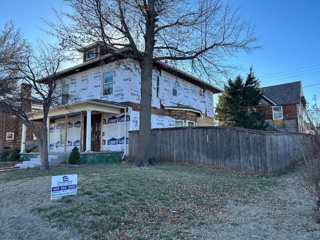 Two-story house wrapped for exterior renovation