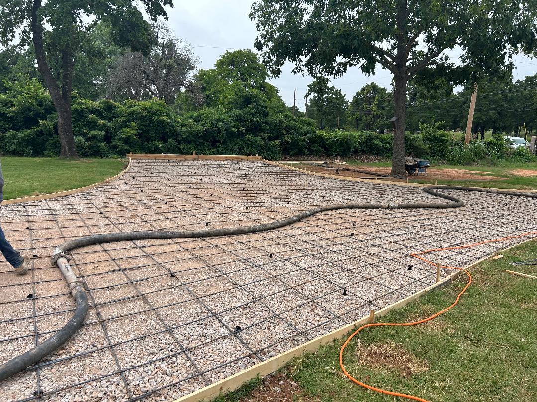 Concrete slab prep with rebar grid and hose