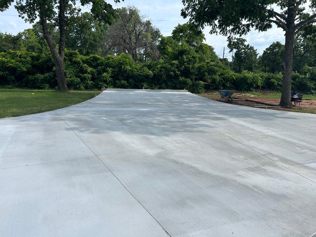 Freshly poured concrete pad with surrounding trees